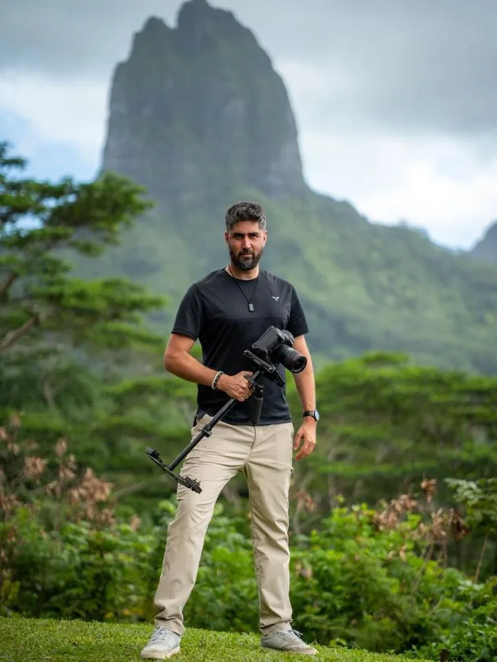 Alex filming in a tropical mountain landscape
